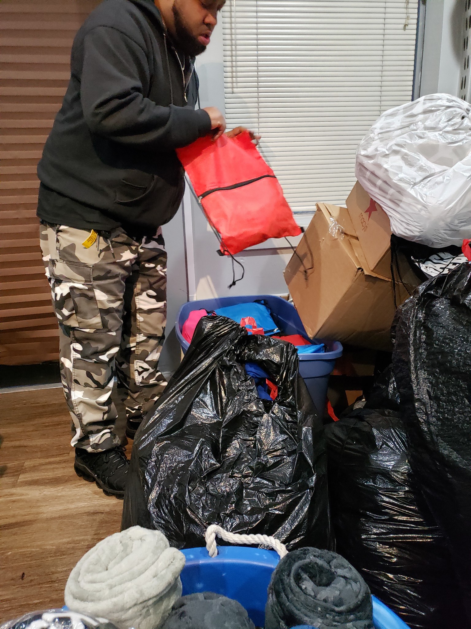 Volunteer sorting supply bags for community outreach